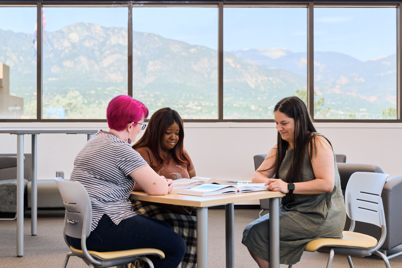 students huddling in learning commons