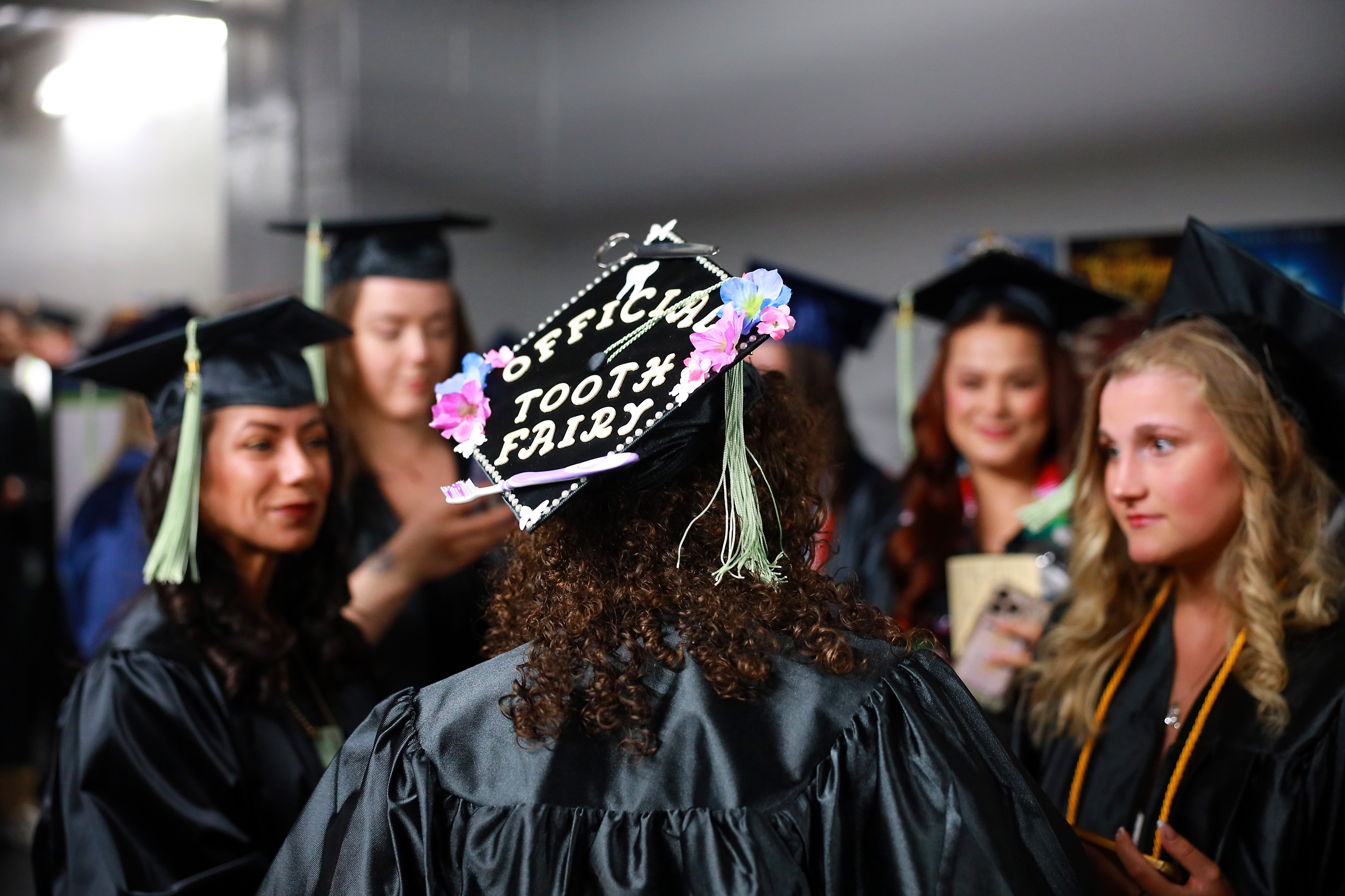PPSC students at commencement with decorated graduation caps