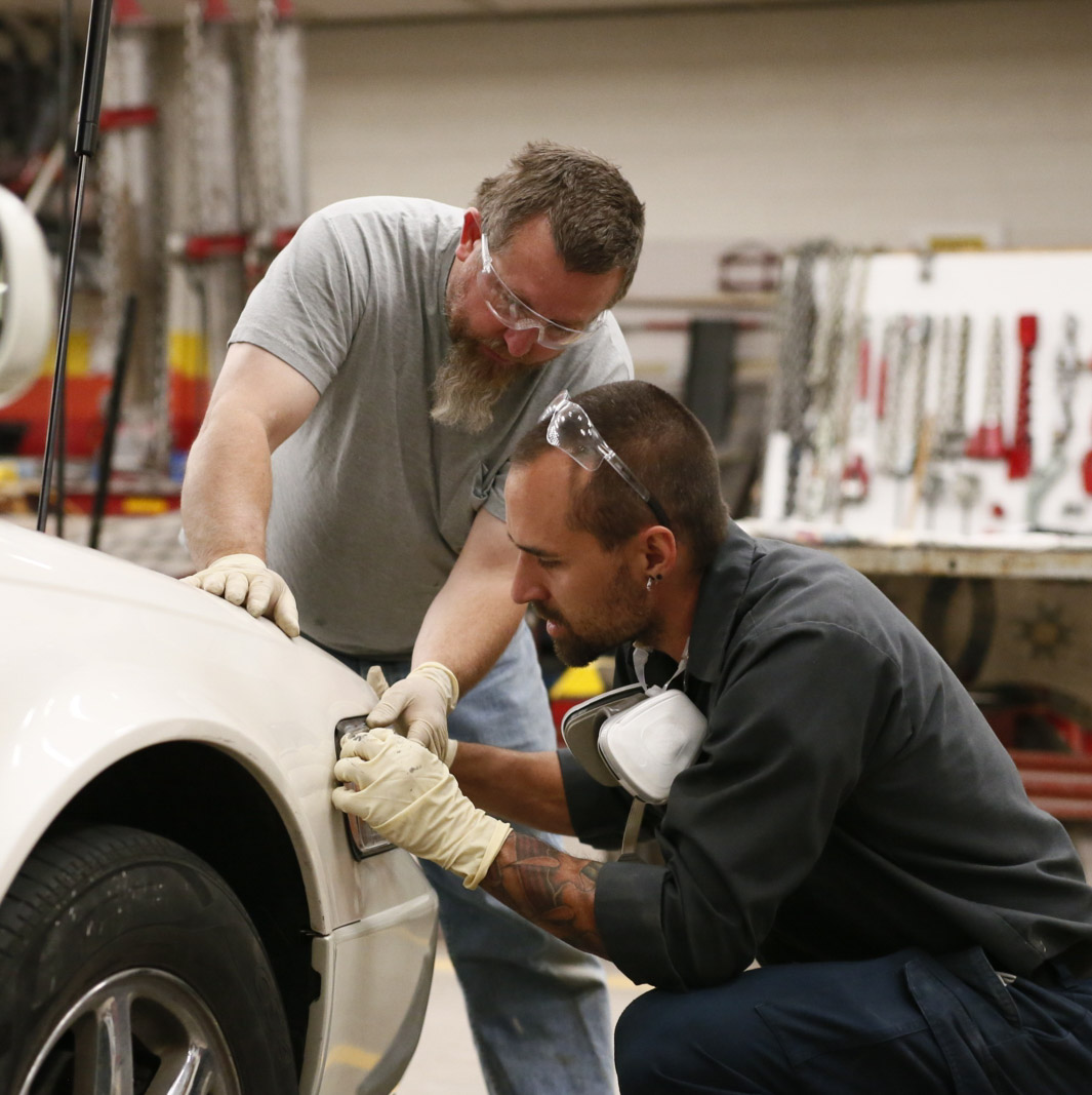 Automtoive collision students working on a car