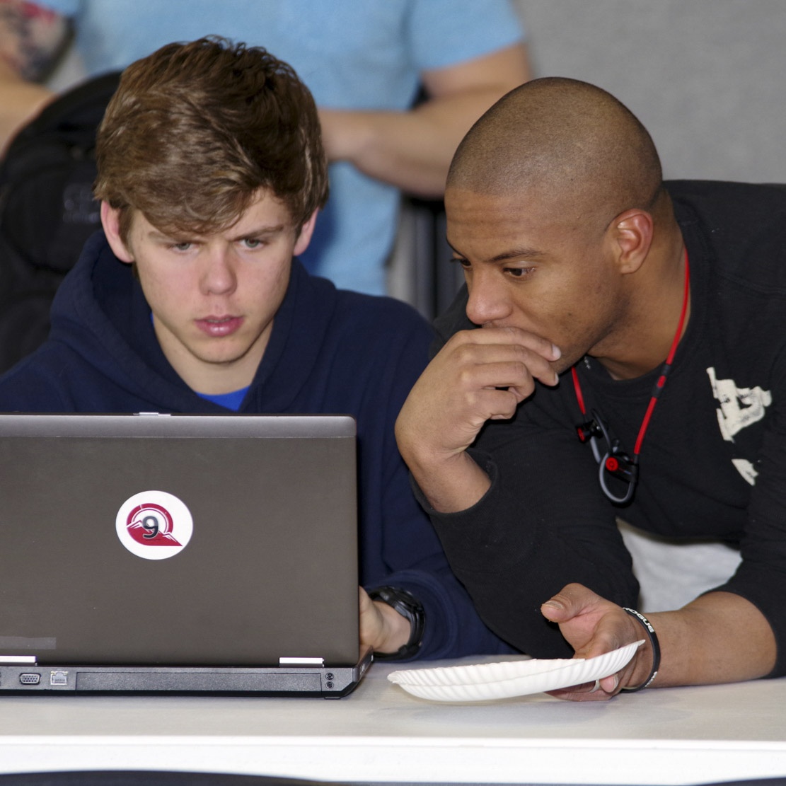 Students looking at a computer