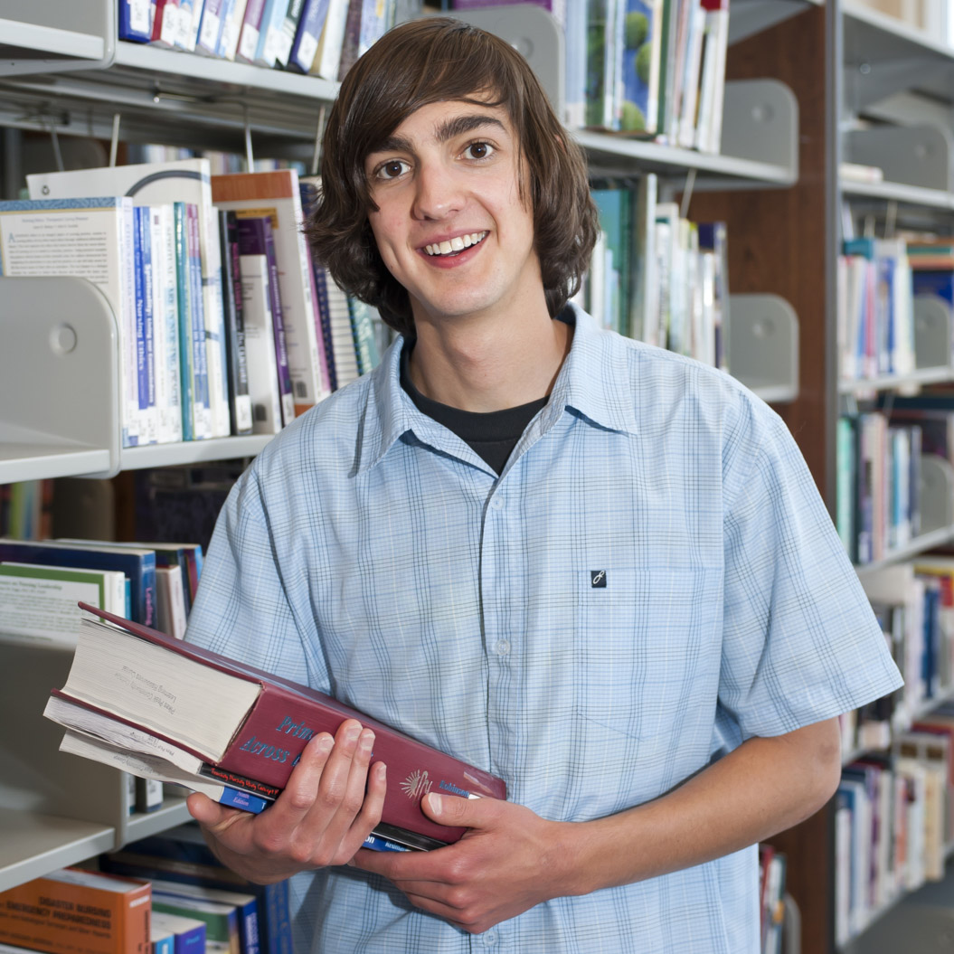 student near bookshelves