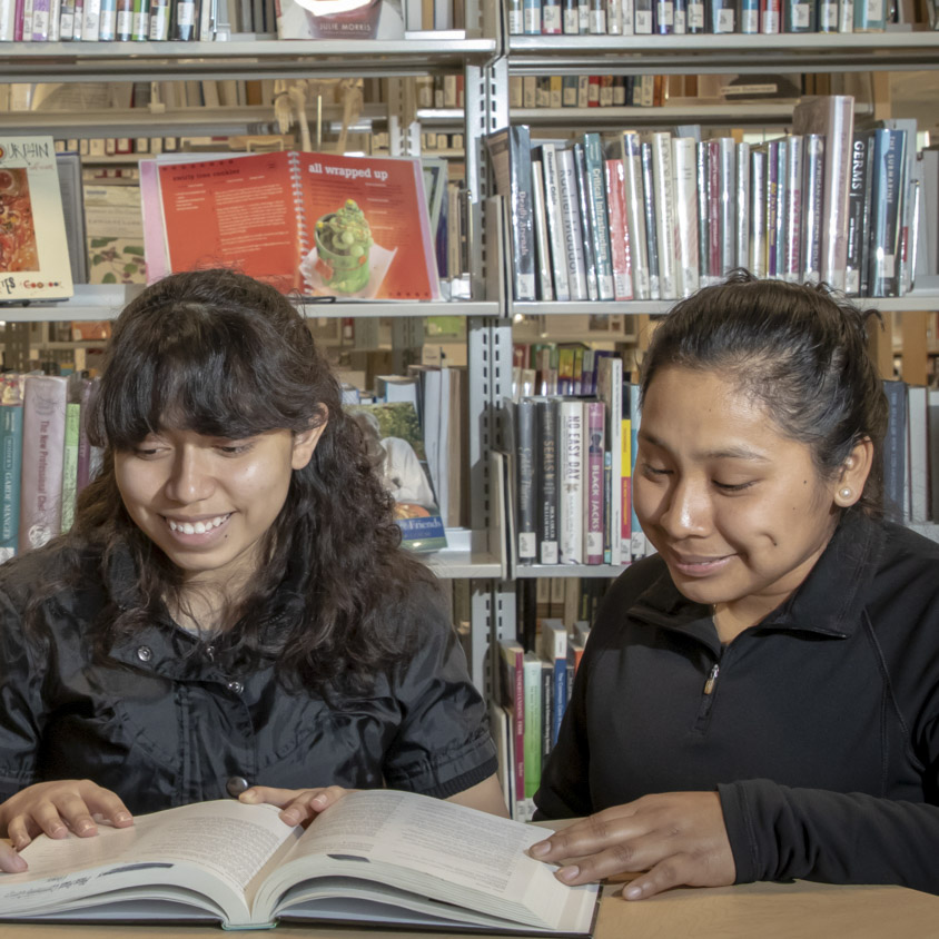 Student holding large book