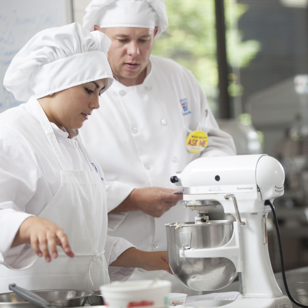 two chefs using table mixer
