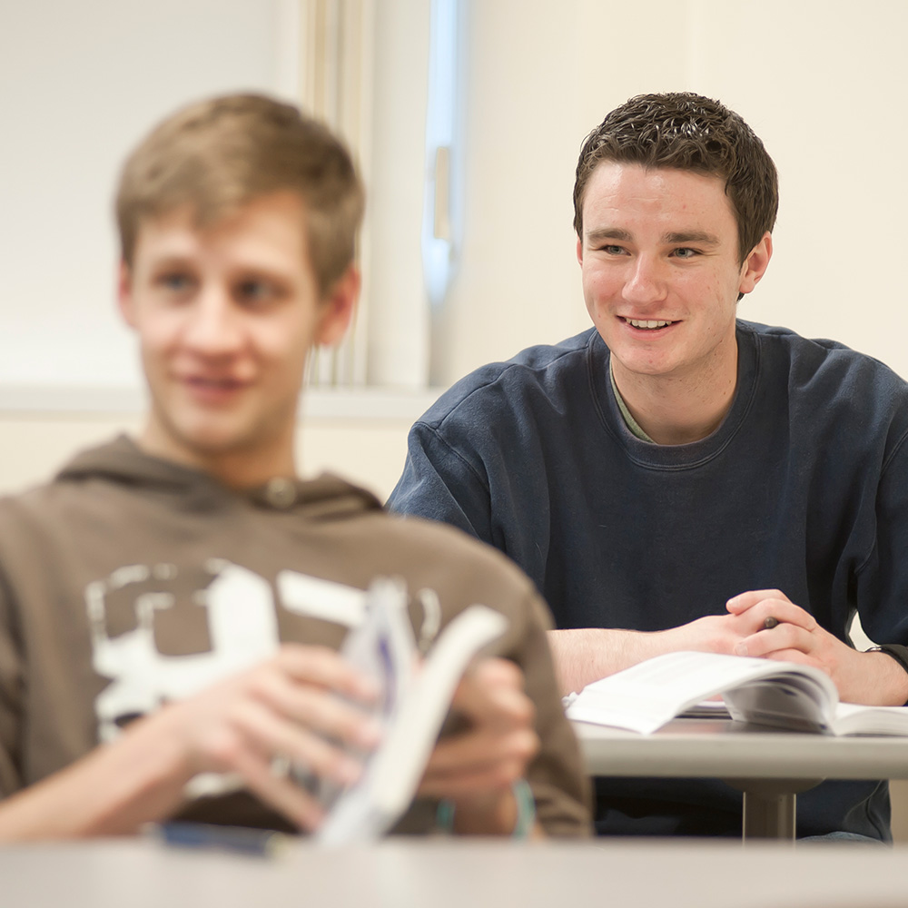 Student taking notes in classroom
