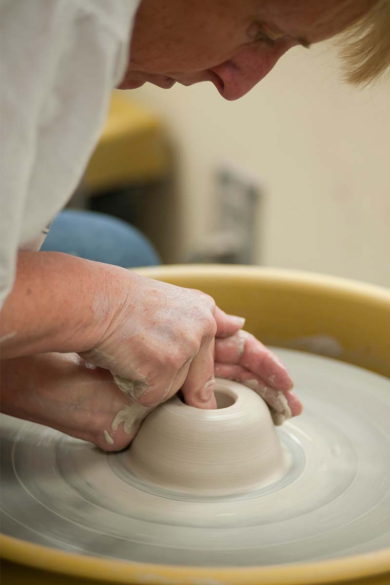 Hands working on pottery wheel. Sculptor, Potter. Human Hands