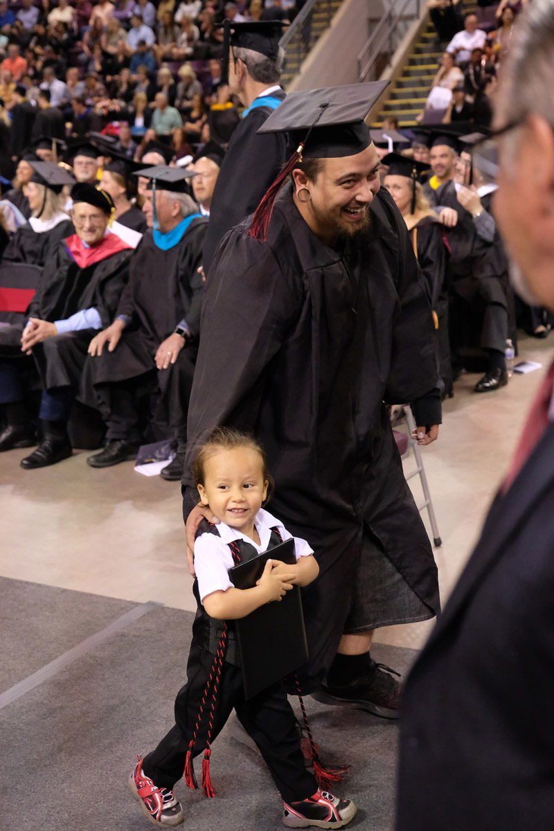 ppcc student with their child at commencement ceremony 
