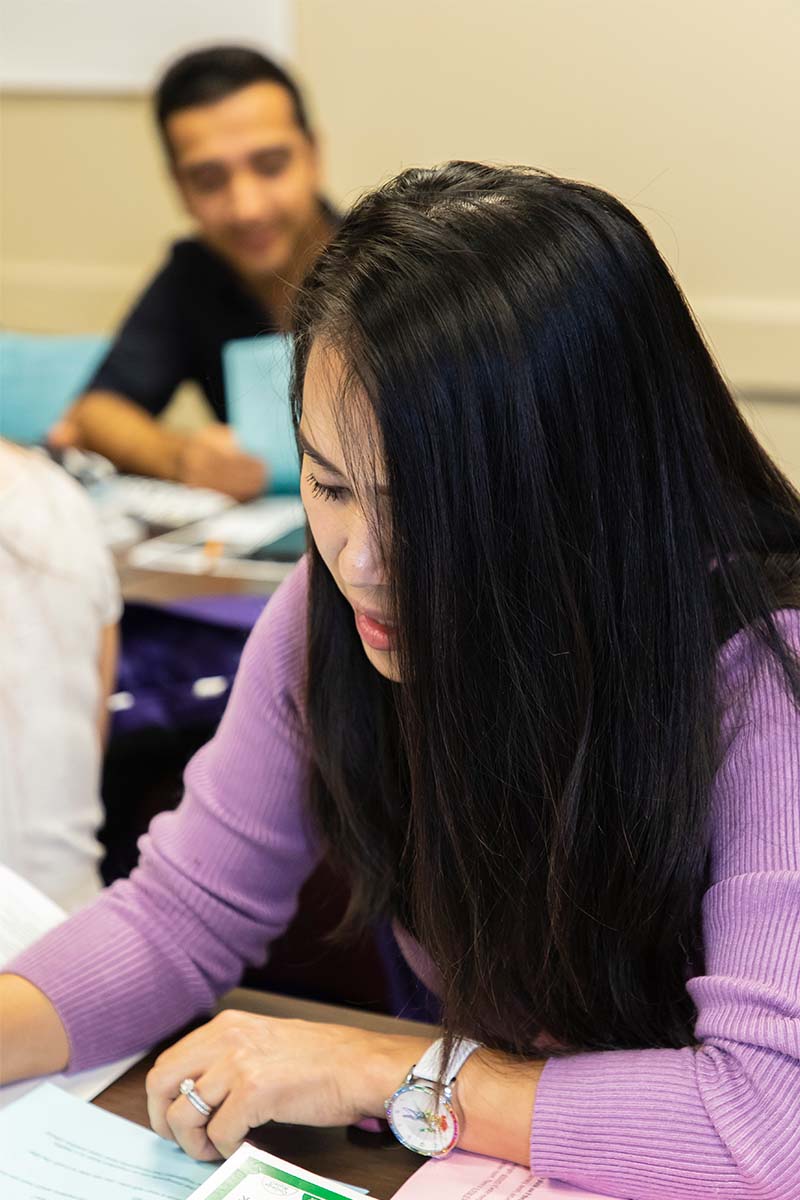 Student looking at papers on desk