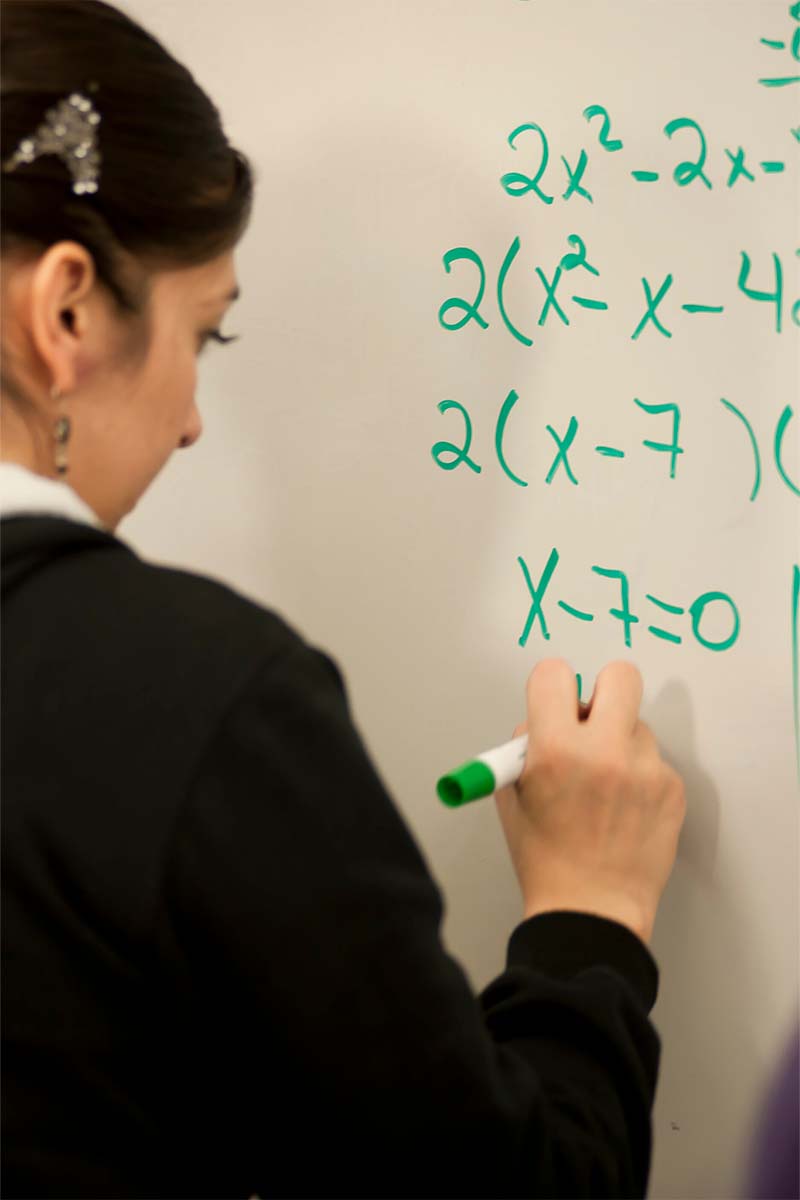 A student writing on a whiteboard