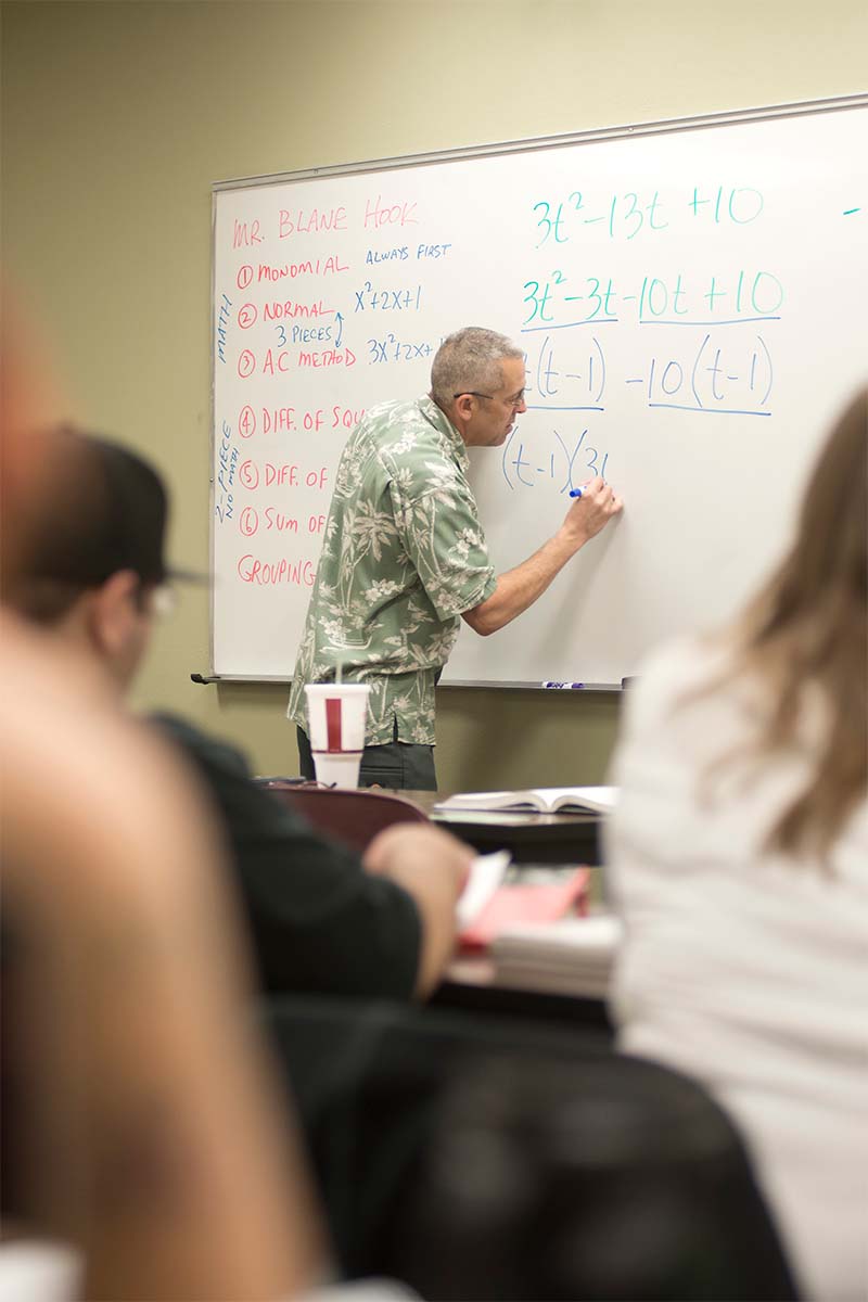 An instructor writing on a whiteboard