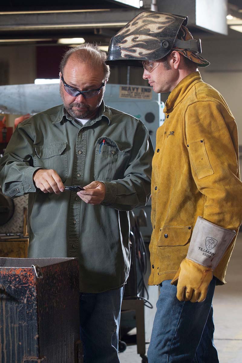 welding student and instructor