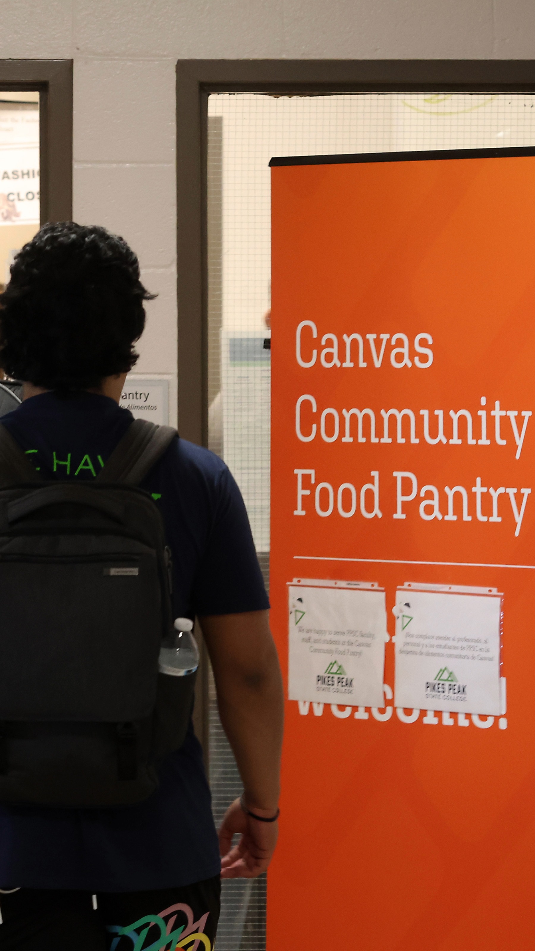 Student walking into canvas community food pantry
