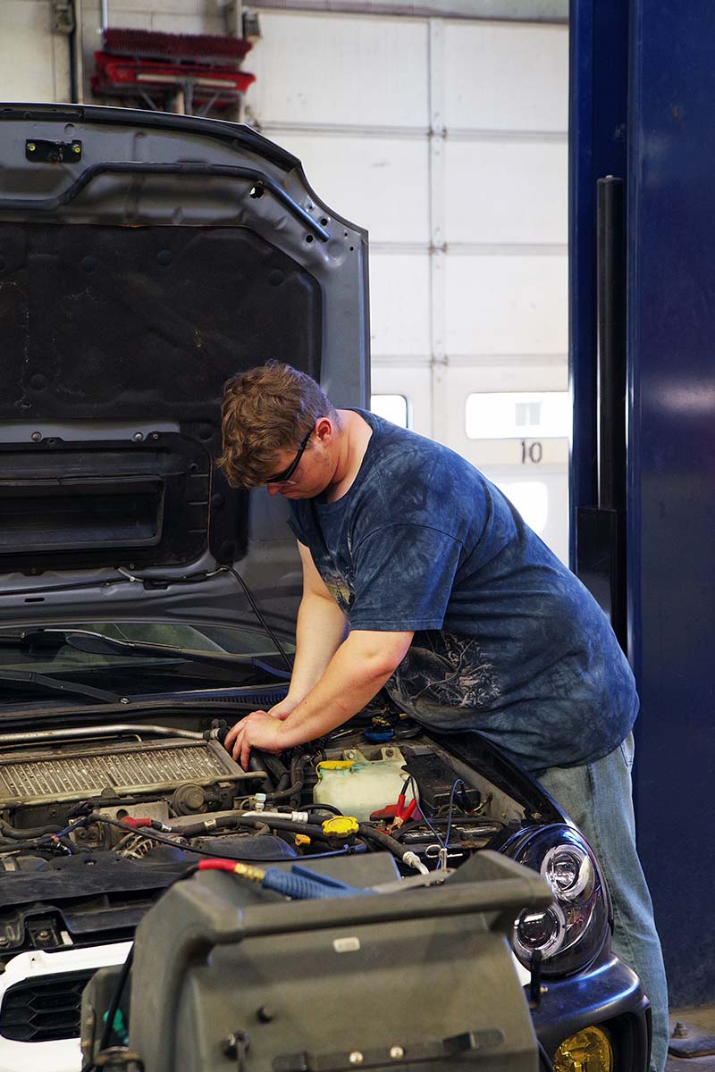 student working on car