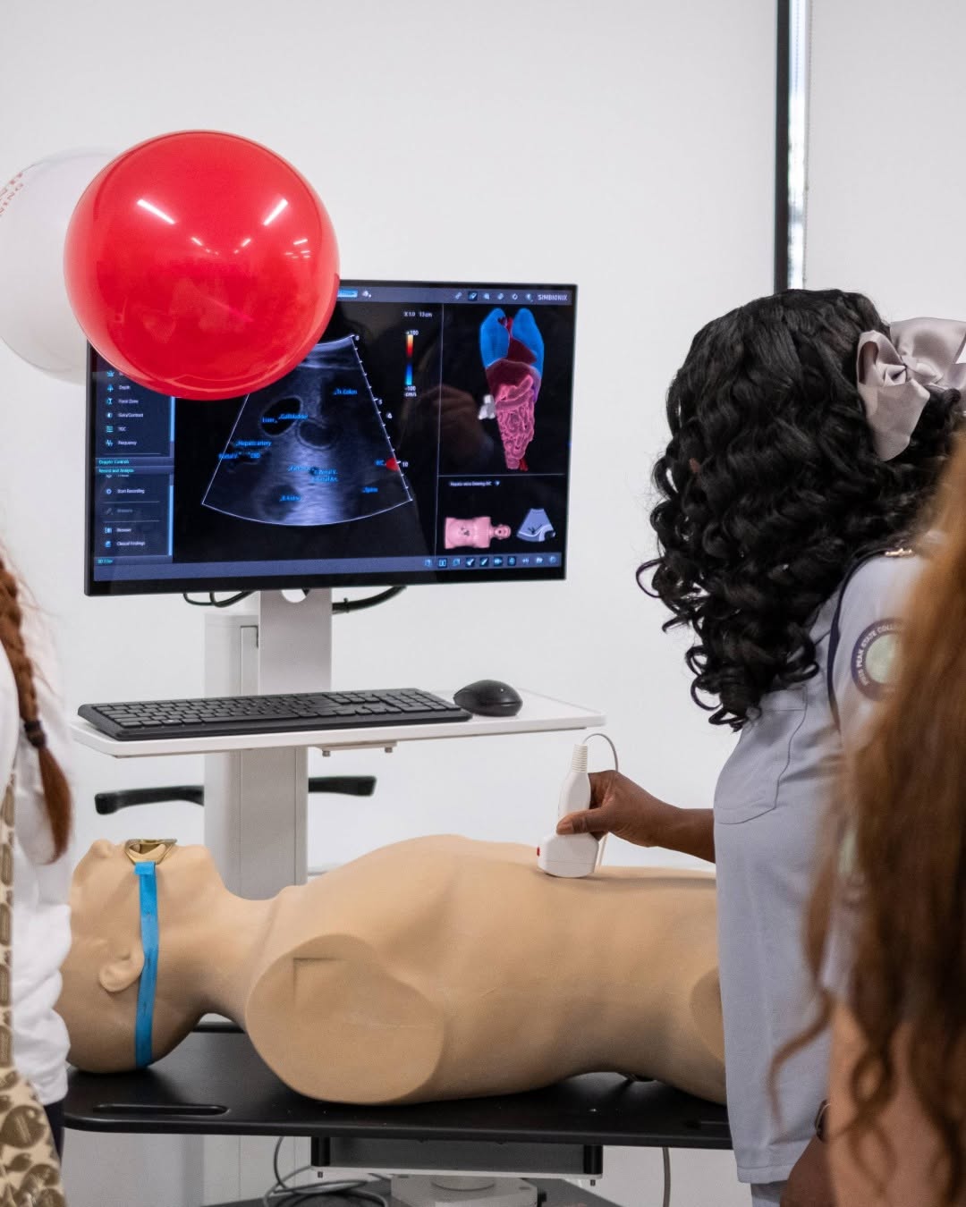 student taking ultrasound on dummy