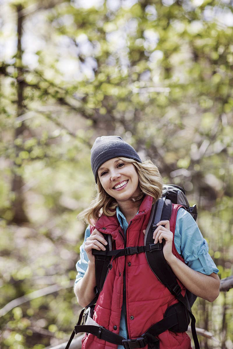 woman standing in a forest