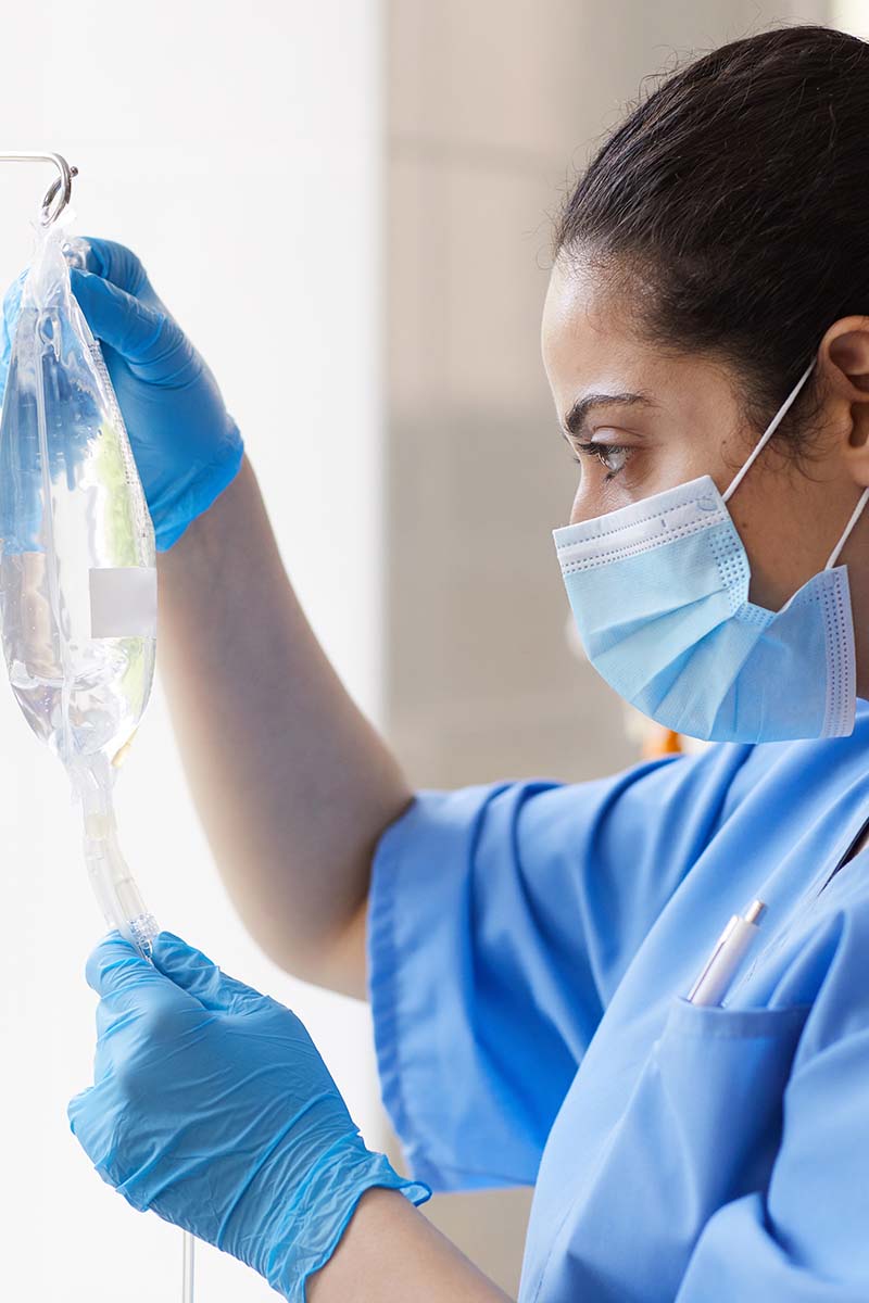 nursing student working with IV bag