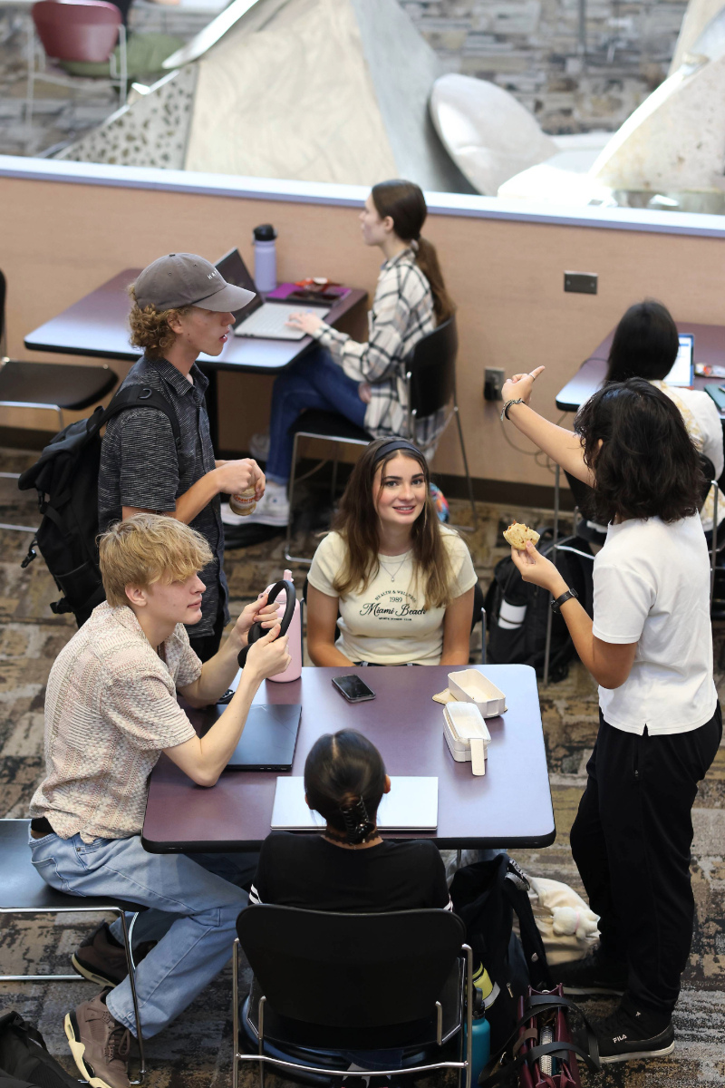 5 Students Sitting around a table together
