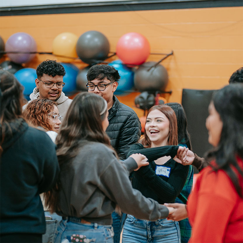 Students talking and laughing at an event