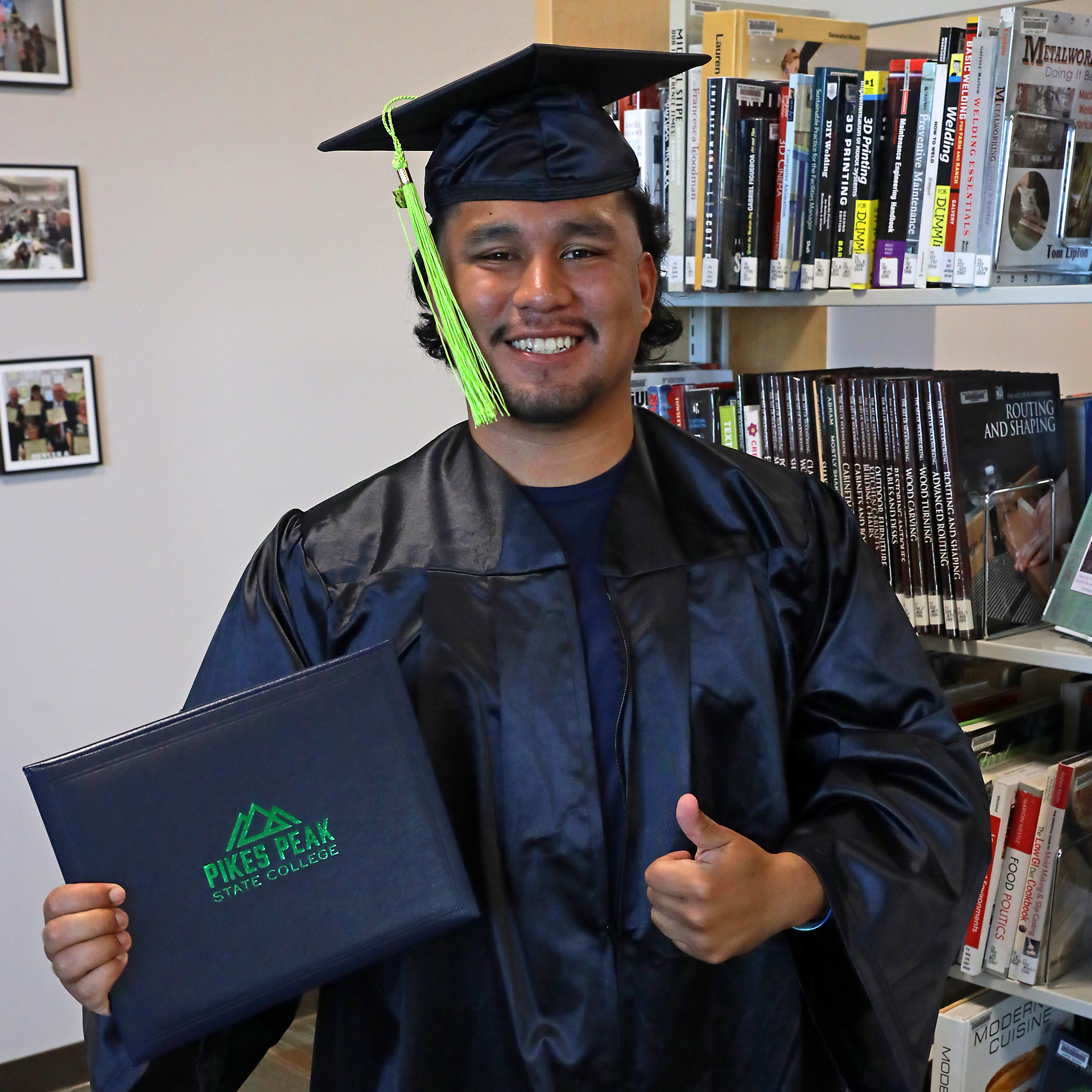 Student in Cap and Gown with Diploma