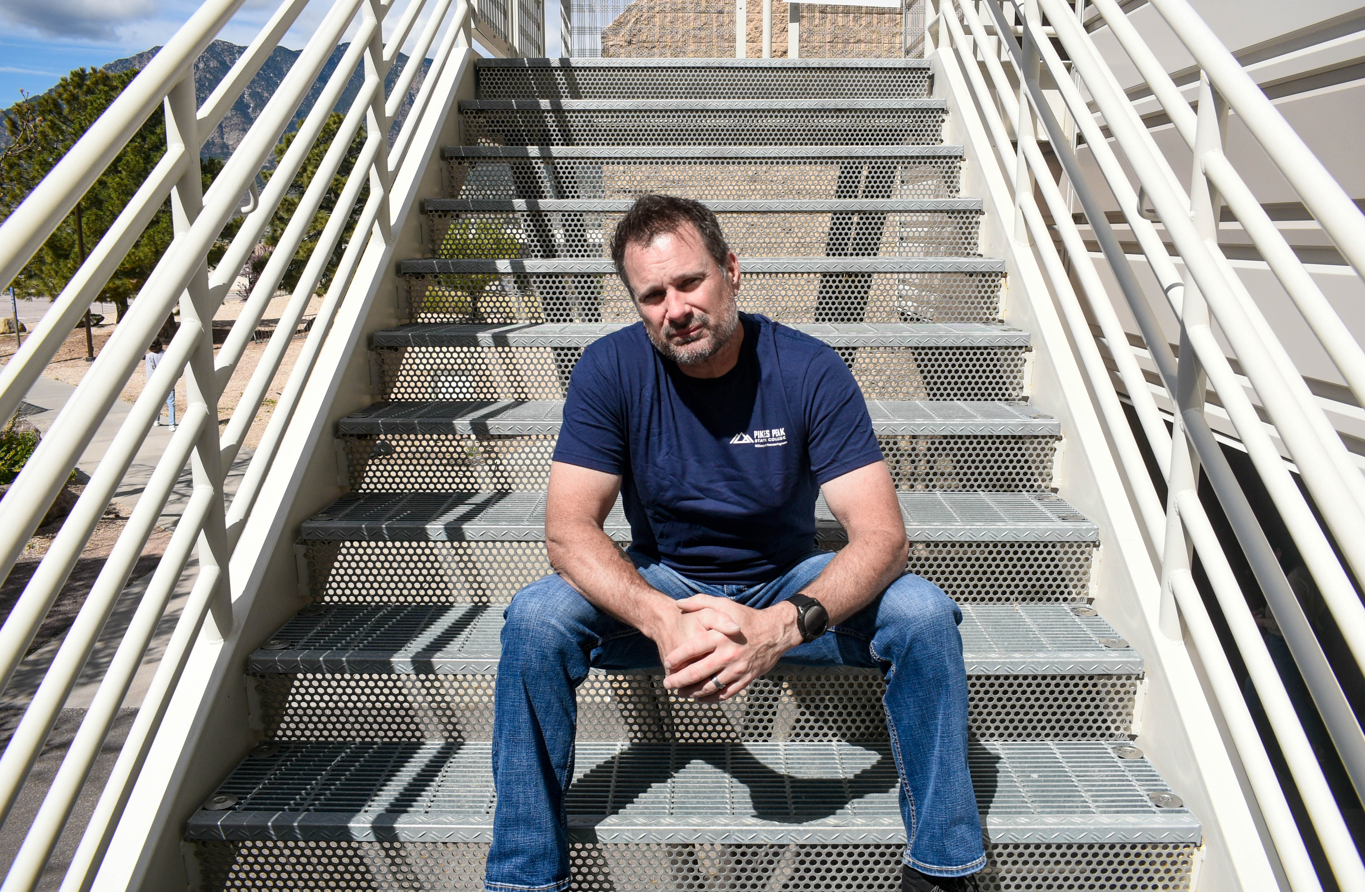 military student sitting on stairs at Centennial Campus