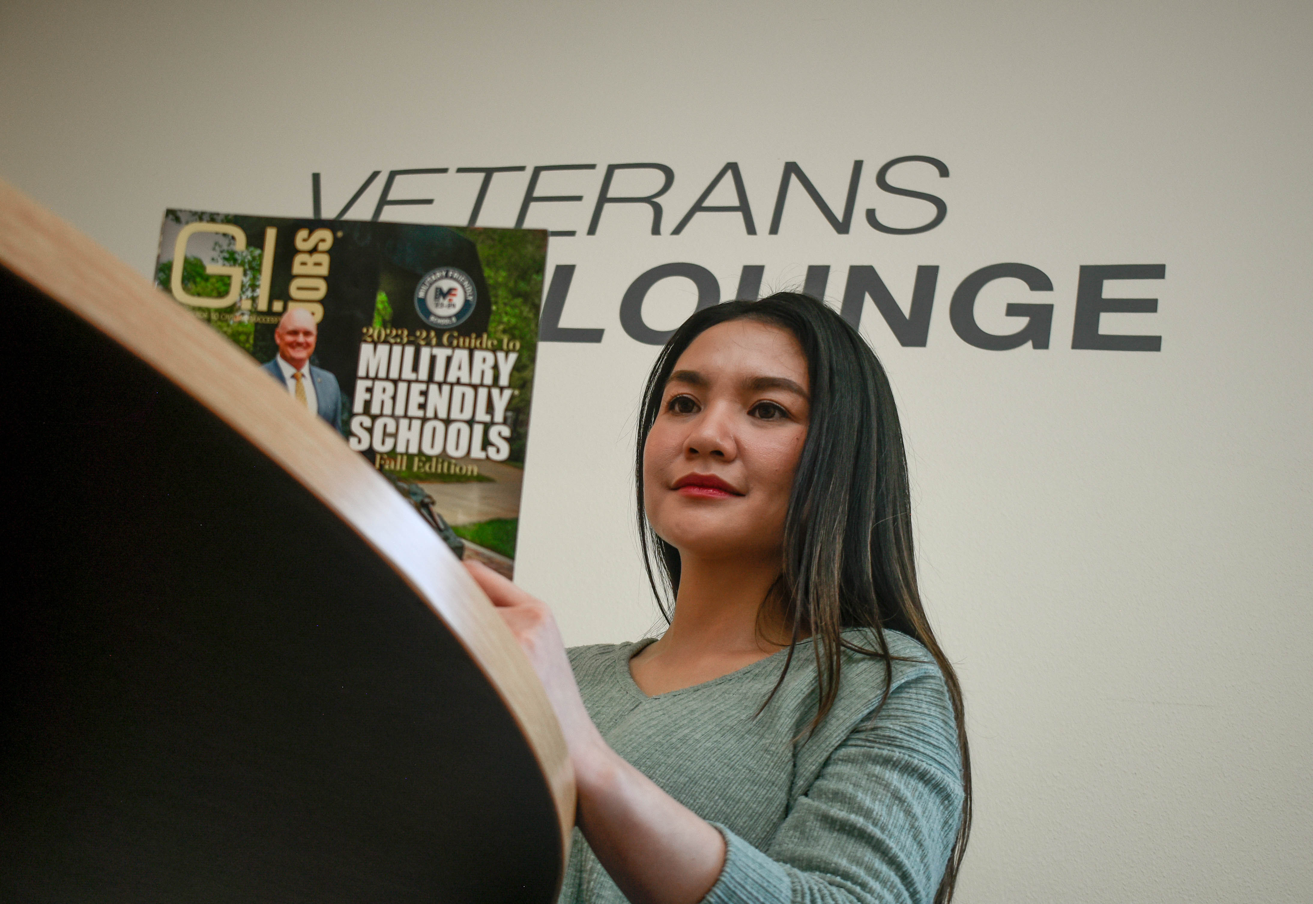 student reading a miltiary magazine 