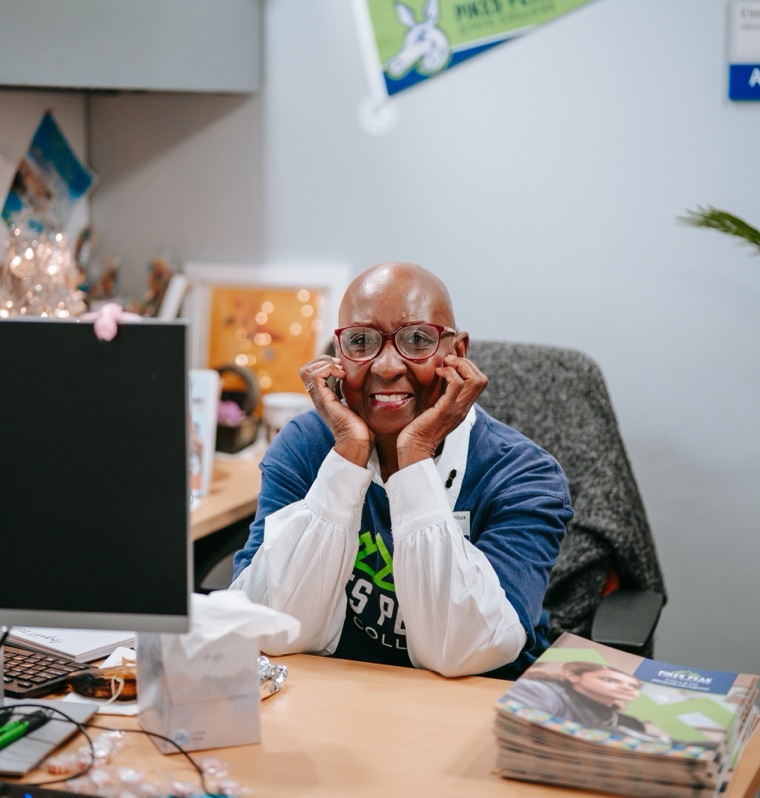 PPSC staff member smiling at her desk