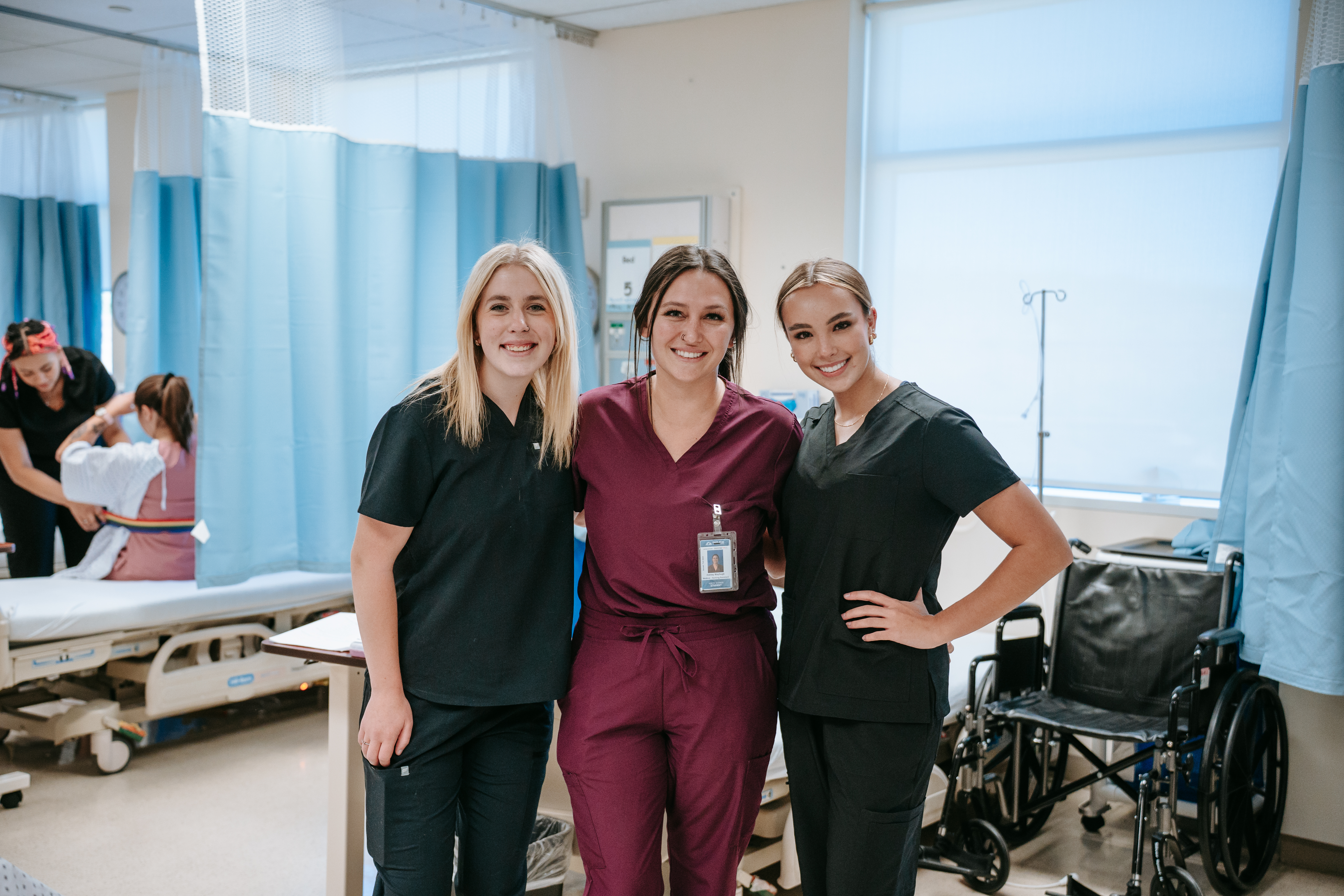 3 PN Students smiling together 