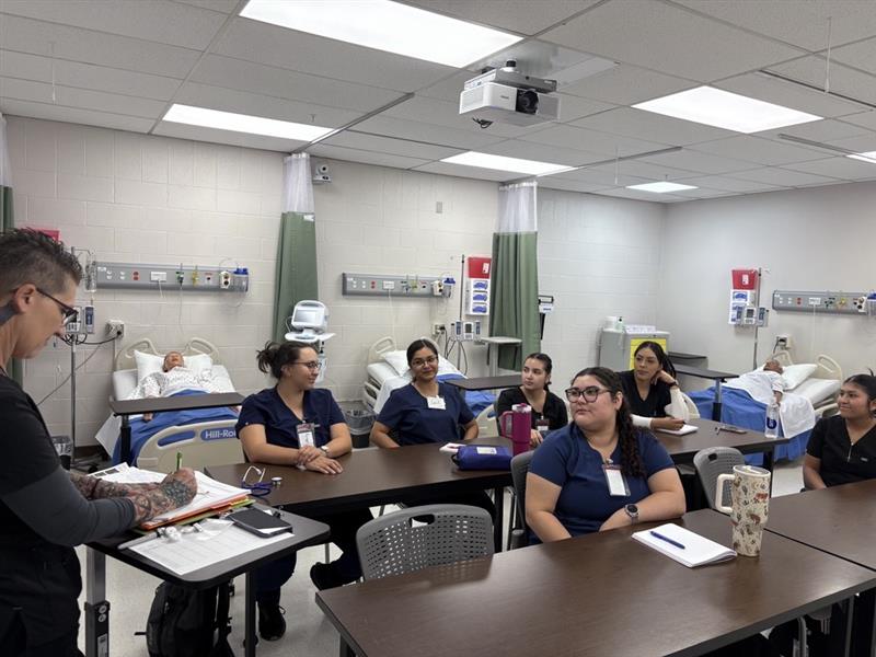 nursing student working with IV bag